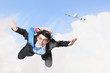 Young businessman flying with parachute on back