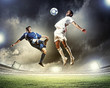 two football players striking the ball
