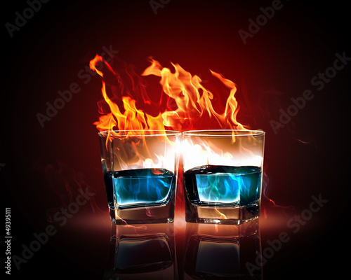 Photo: Two glasses of burning emerald absinthe Two glasses of burning emerald absinthe