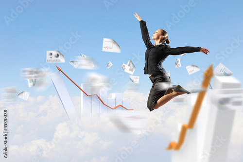 Photo: businesswoman in black suit jumping businesswoman in black suit jumping