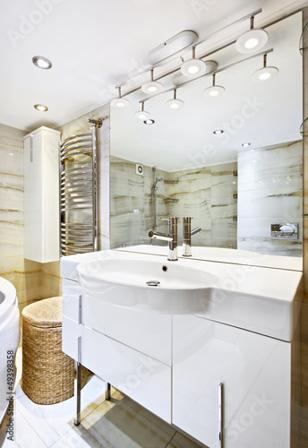 Photo: Wash stand with mirror in modern white bathroom interior Wash stand with mirror in modern white bathroom interior