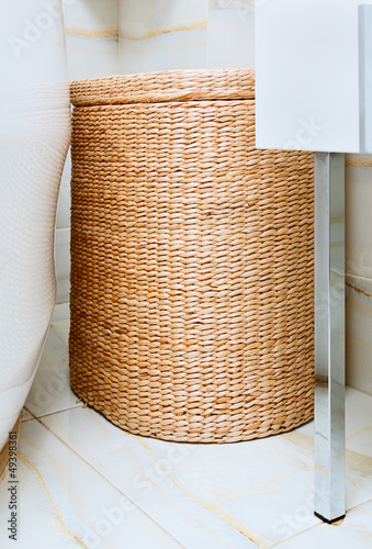 Photo: Wicker clothes basket in the bathroom, interior detail Wicker clothes basket in the bathroom, interior detail