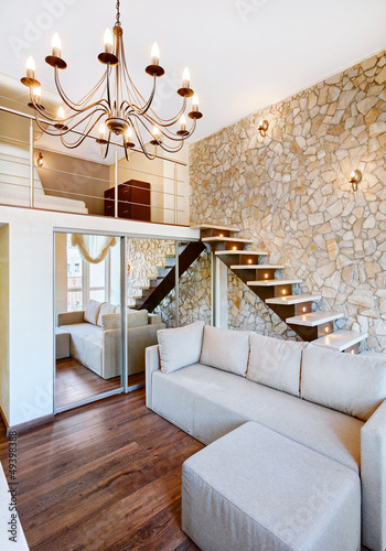 Photo: Modern style two-high living-room interior with staircase and st Modern style two-high living-room interior with staircase and st