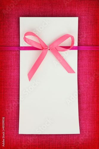 Photo: Empty card on pink fabric texture Empty card on pink fabric texture