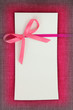 Photo: Empty card on pink fabric texture Empty card on pink fabric texture