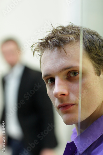 Photo: Pane,man's face portrait, another man in background Pane,man's face portrait, another man in background