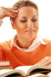 Young woman reading a book. Female student learning
