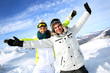 Cheerful couple of skiers stretching arms up