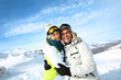 Cheerful couple standong on mountain peak