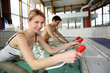 People exercising with aquatic bikes in spa center