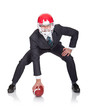 Foto: Competitive businessman playing american football Competitive businessman playing american football