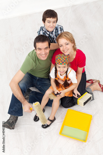 Photo: Family with paint preparing to redecorate their home Family with paint preparing to redecorate their home