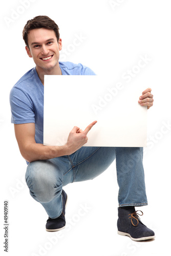 Photo: Young man pointing at blank board Young man pointing at blank board