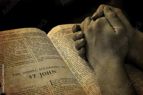 Photo: Hands Praying on Bible Hands Praying on Bible