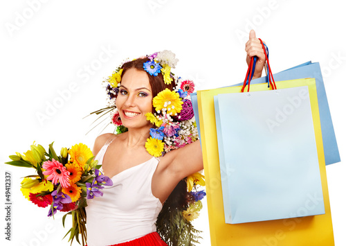 Photo: Woman with shopping bag holding flower. Woman with shopping bag holding flower.