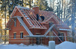 Unfinished house of brick site under construction with wooden ro