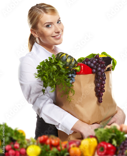 Photo: Portrait of happy business woman holding a shopping bag full of Portrait of happy business woman holding a shopping bag full of