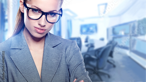 Photo: Modern business woman in the office with copy space Modern business woman in the office with copy space