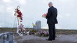 Man standing at new grave