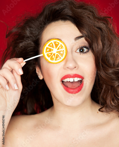 Photo: Beautiful happy young woman with lollipop Beautiful happy young woman with lollipop
