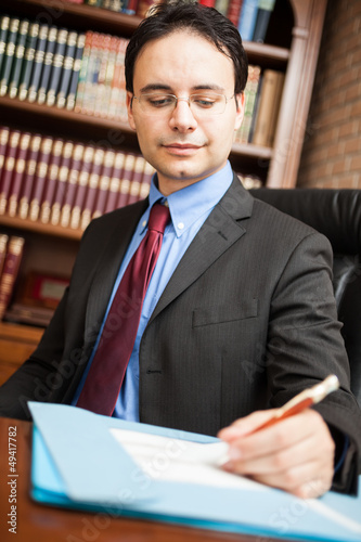 Photo: Man writing on a document Man writing on a document