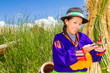 Woman, in indian costume on Uros island Peru