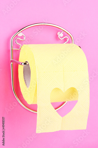 Photo: Roll of toilet paper on holder fixed to wall Roll of toilet paper on holder fixed to wall