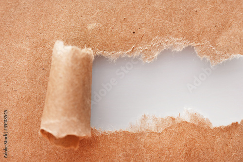 Photo: Torn kraft paper background Torn kraft paper background