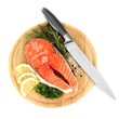 Fresh salmon steak on cutting board, isolated on white