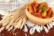 Appetizing village potatoes in bowl on wooden table close-up