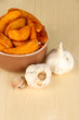 Appetizing village potatoes in bowl on wooden table close-up