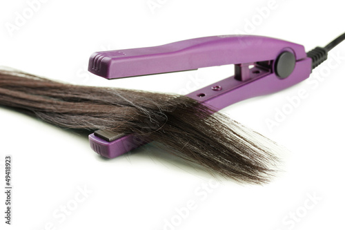 Photo: Hair straighteners and hair, isolated on white Hair straighteners and hair, isolated on white