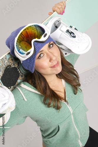 Photo: Snowboard and Fun Loving Female in Teal Snowboard and Fun Loving Female in Teal