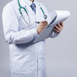 Male doctor fills patient card