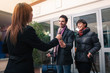 Photo: Happy young couple entering in hotel with key of the room. Happy young couple entering in hotel with key of the room.