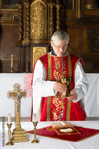Photo: Priest during mass Priest during mass