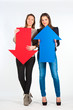 Two beautiful women holding red and blue arrow, up and down