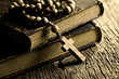 rosary beads on old books