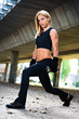 Woman lifting weights in urban setting