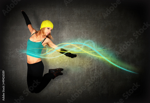 Photo: Woman jumping/dancing with glowing lines around her Woman jumping/dancing with glowing lines around her