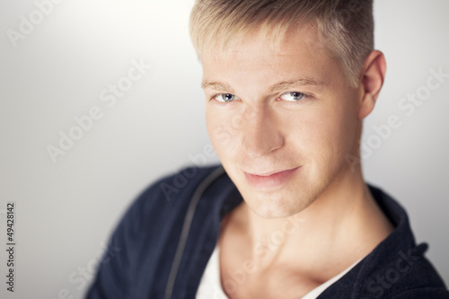 Photo: Close up of attractive young man looking seductive. Close up of attractive young man looking seductive.