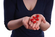 woman presenting red ceramic hearts in her hands