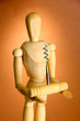 Mannequin with corkscrew, on brown background