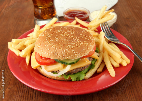 Photo: Tasty cheeseburger with fried potatoes and cold drink, Tasty cheeseburger with fried potatoes and cold drink,