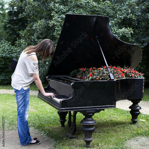 Photo: woman playing on an old piano, woman playing on an old piano,