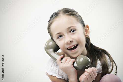 Photo: Little girl with vintage phone Little girl with vintage phone