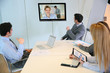 Business people attending videoconference meeting