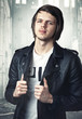 portrait of a young man in a black leather jacket