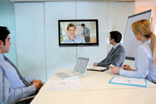Photo: Business people attending videoconference meeting Business people attending videoconference meeting