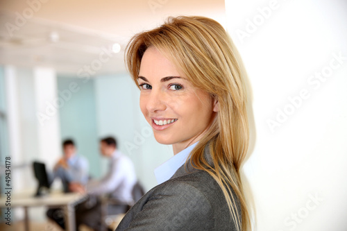 Photo: Beautiful blond businesswoman in meeting room Beautiful blond businesswoman in meeting room